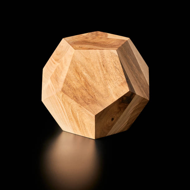 Wooden dodecahedron Handmade wooden regular dodecahedron - Platonic solid lying on a black background platonic solids stock pictures, royalty-free photos & images