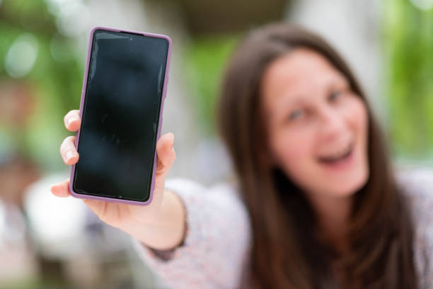 istock the women shows the phone 2041265192