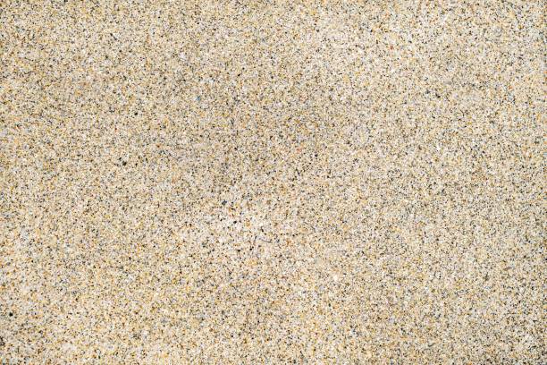 Perfectly flat and uniform wet sand texture on a beach