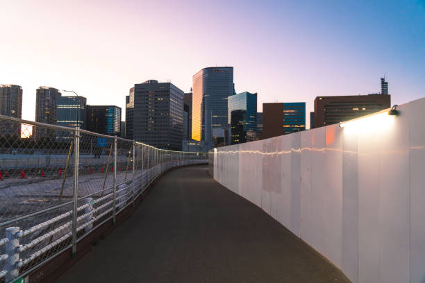 istock Narrow footpath surrounded with Safety Barriers at night 2041271390
