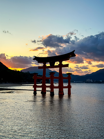 Miyajima, Itsukushima island, Japan - 12.11.2023. Miyajima, The famous Floating Torii gate with beautiful sunset at the background, Itsukushima shrine, Hiroshima prefecture, Japan. Great floating torii