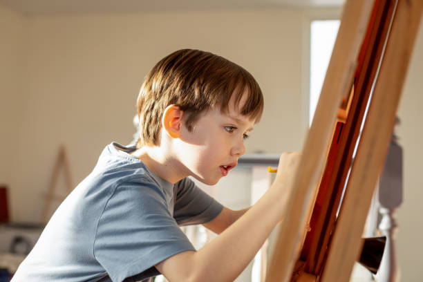 istock 6 year old boy at a drawing lesson 2041284854