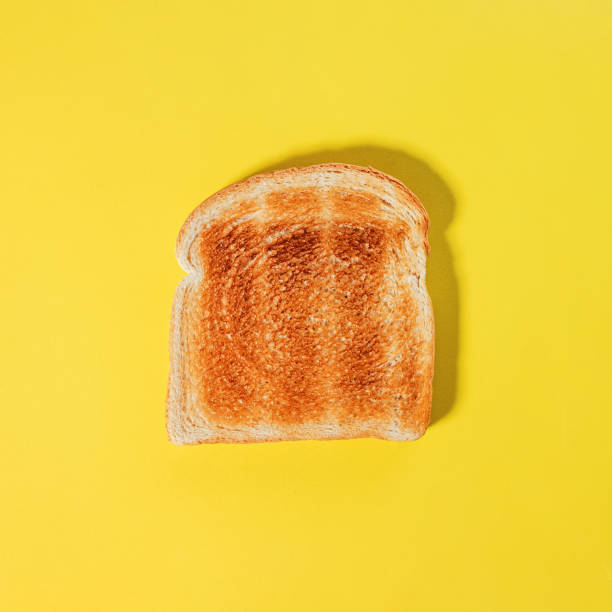 istock Square bread slice, toast on the yellow background 2041290048