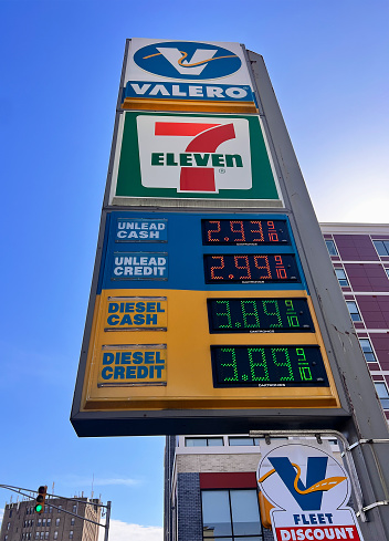 Bloomfield, USA   February 24, 2024\nSign for Valero Gas Station at a 7 Eleven convenience store in Bloomfield, New Jersey.\nThis station is along Bloomfield Avenue a busy street in Bloomfield with many buildings and street lights.