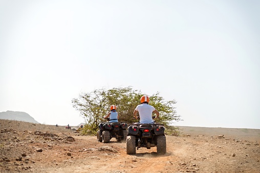 Group quad biking across desert terrain on a holiday trek in Cape Verde Islands
