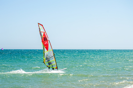 Surfers on beach on sunny day trying to catch wind in Torremolinos, Spain on July 4, 2023