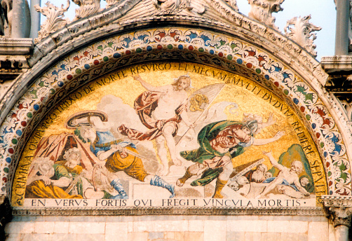 Venice, Veneto, Italy: western façade lunette with a Byzantine mosaic depicting Christ's resurrection and ascension to heaven, framed by phrases from St Mark's gospel.
