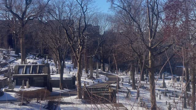 Cemetery on sunny, snowy day. Trinity Church Cemetery and Mausoleum in New York City
