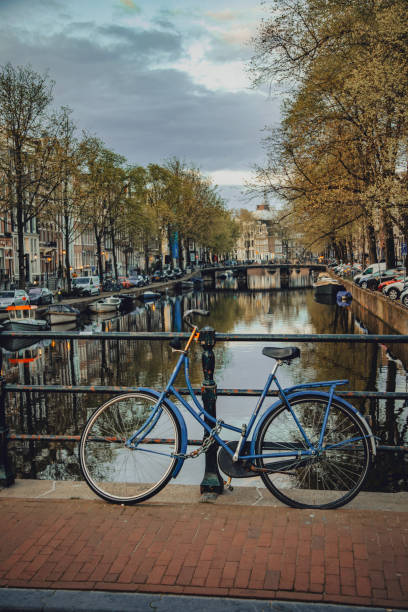 istock Iconic Amsterdam: Close-Up of Parked Bicycle by Canal 2041451640
