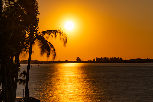 Orange sunset at Siesta Key beach with sunshine, Sarasota, Florida