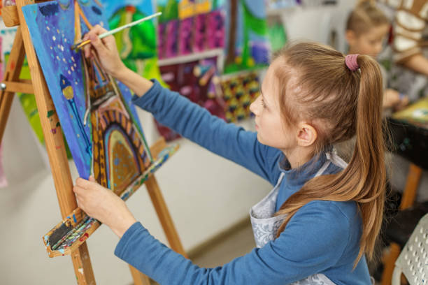 istock Focused Child Artist Painting on Canvas in Class 2041456798