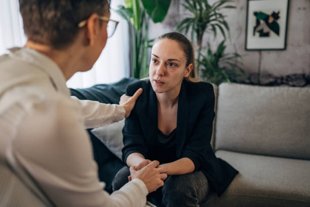 istock A therapist extends a comforting hand to a patient during a session. 2041456811