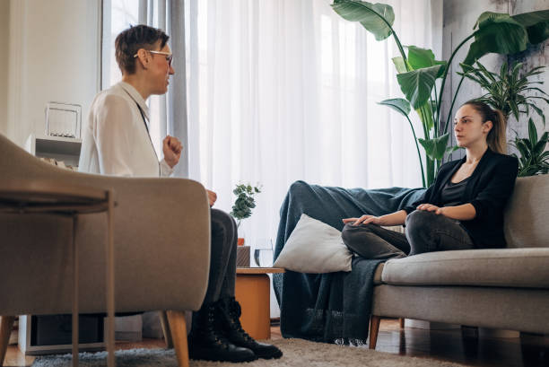 istock Two individuals engage in a breathing exercise during a therapy session. 2041464138