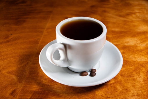 Cup of coffee with coffee grains