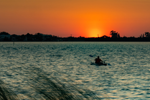 Orange sunset at Siesta Key beach with sunshine, Sarasota, Florida