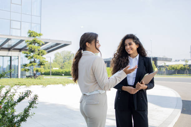 istock Two businesswomen are talking outside 2041530013