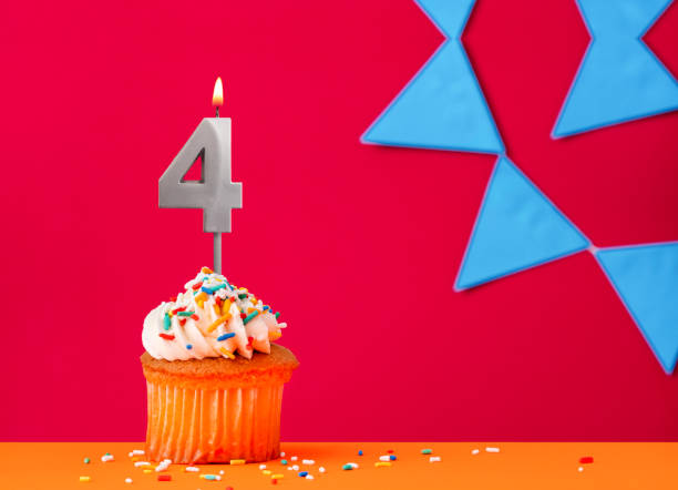 istock Number 4 candle with birthday cupcake on a red background with blue pennants 2041655572