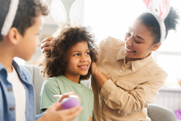 istock Happy family : mother and kids wearing cute bunny ears holding egg celebration Easter holidays 2041670151