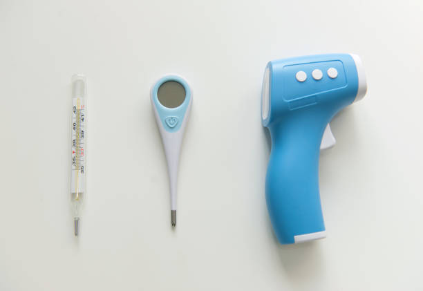 Best Thermometer for home. Three different types of thermometers on white background. Mercury, infrared contactless Thermometer.