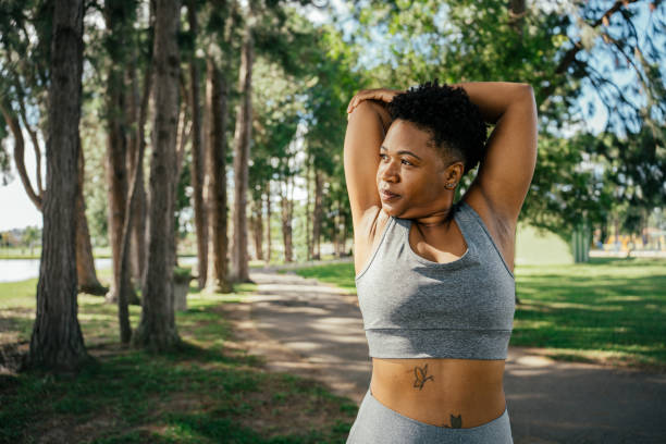 istock Woman stretching her arm in the park 2041737301