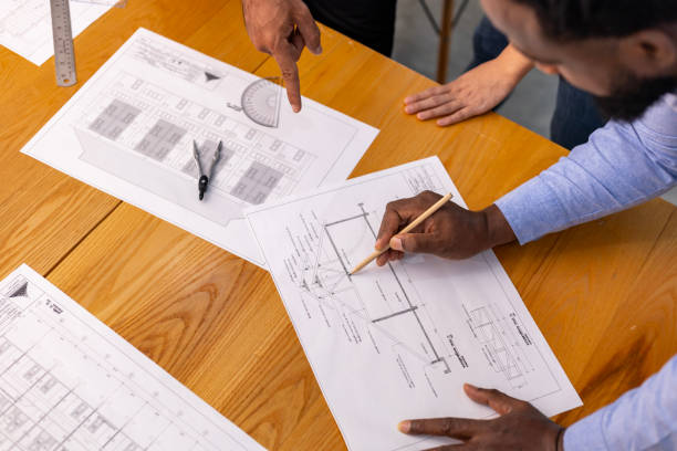 istock Architectures and engineer discussing and brainstorming on floor plan over clean energy and power saving eco-friendly house design using solar panel for green industry and futuristic home development 2041788017
