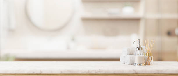 istock Toiletries and empty space on a white marble tabletop in a modern bright and clean bathroom. 2041789583