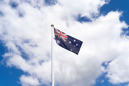 Australian flag on a white pole.