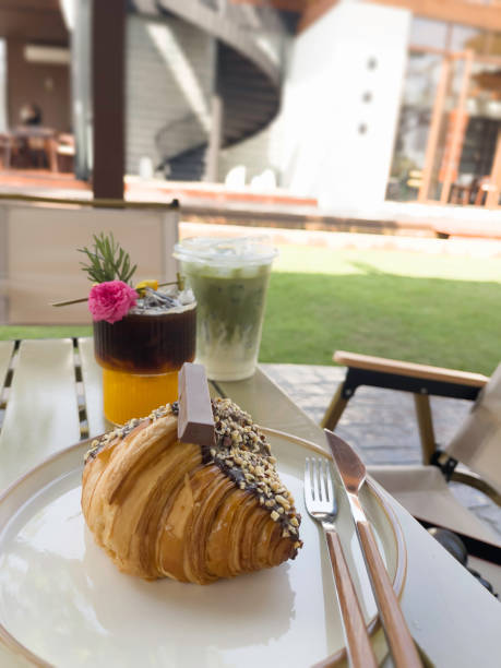 istock Single chocolate croissant and iced drink on table 2041868205
