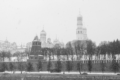 Climate change leads to global natural disasters, abnormal temperatures, heavy snowfalls, typhoons and droughts. Winter view of the Moscow Kremlin during heavy snowfall. Black and white.