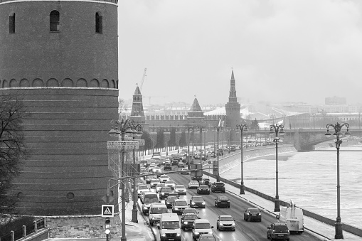 Climate change leads to global natural disasters, abnormal temperatures, heavy snowfalls, typhoons and droughts. View of the Kremlin embankment from the Bolshoy Kamenny Bridge during a snowfall. Black and white.