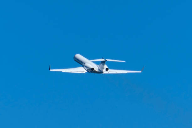 Small corporate jet taking off at airport.