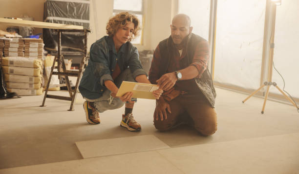 istock Tiles for a refurbished kitchen: Home improvement team discussing kitchen renovation and flooring upgrade 2041939274