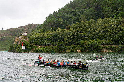 Training in a typical boat of the Cantabrian coast at the entrance to the bay of the town of Pasajes. Basque Country. Spain. August 3, 2023.