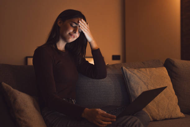 istock Stressed woman at late night having strong terrible headache attack after computer laptop study, sleepy exhausted girl suffering from chronic migraine massaging temples to relieve head ache tension 2041940840