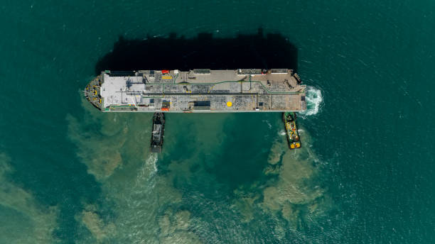 istock Aerial top view Tugboat pushing dragging Large RoRo (Roll on Roll off) in sea. 2041950247