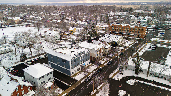 Winter cityscape in Madison, New Jersey. Houses along Greenwood Ave are covered with snow