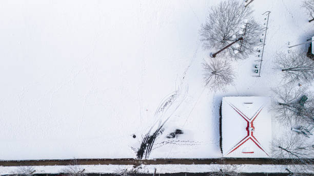 istock Snow footprints run along a built structure on a snow-covered stadium in park of Madison, NJ 2041950773