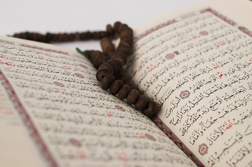 Close-up view of Tasbih on the Quran, with selective focus