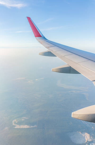 istock View from the airplane window at a beautiful cloudy sky and the airplane wing 2041998721