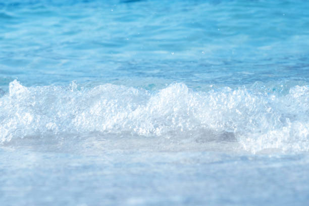 Beautiful white sand beach with soft ocean wave in summer time.