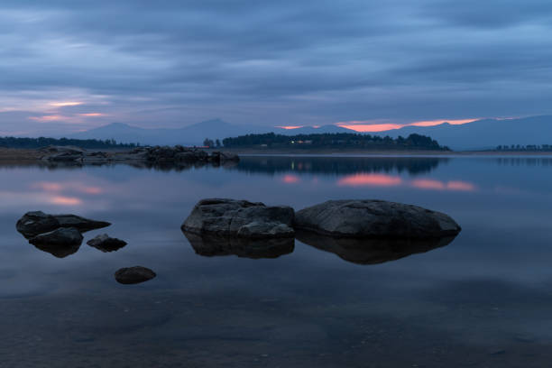 istock a sunset over the lake and a few stones in it 2042030716