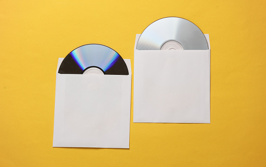 Mockup of CD discs in Paper packs on yellow background