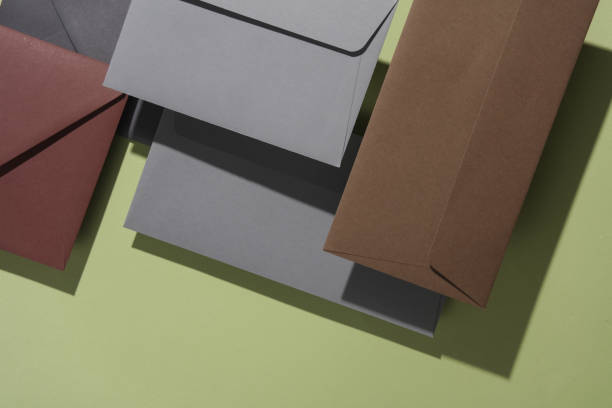 istock Floating envelopes with card on green background with shadow. Minimalism, modern business still life 2042044784
