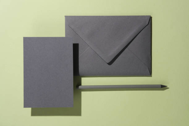 istock Floating envelope with invitation card on green background with shadow. Minimalism, modern business still life 2042044786