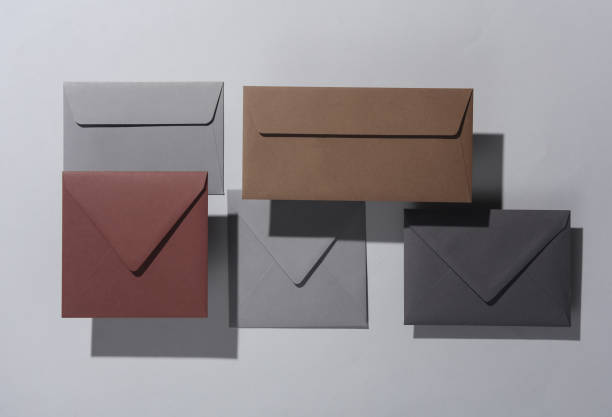 istock Floating envelopes on gray background with shadow. Minimalism, modern business still life, creative layout 2042045300