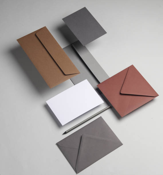istock Floating envelopes and card on gray background with shadow. Minimalism, modern business still life, creative layout 2042045821