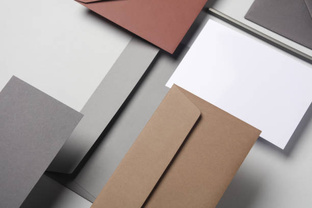 istock Floating envelopes and card on gray background with shadow. Minimalism, modern business still life, creative layout 2042048427