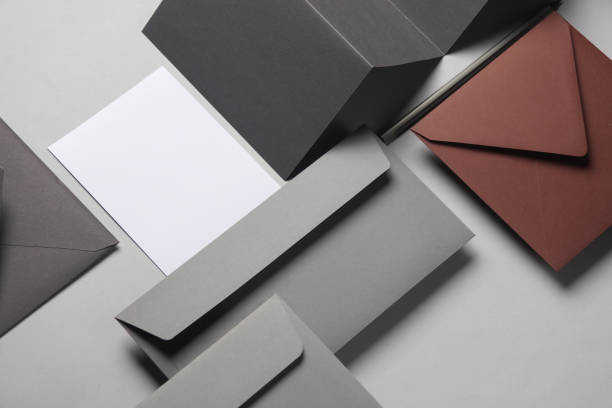 istock Floating envelopes and brochure, cards on gray background with shadow. Minimalism, modern business still life, creative layout 2042048436