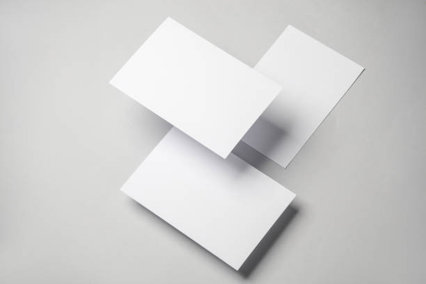 istock Floating blank white cards on gray background with shadow. Minimalism, modern business still life, creative layout 2042049480