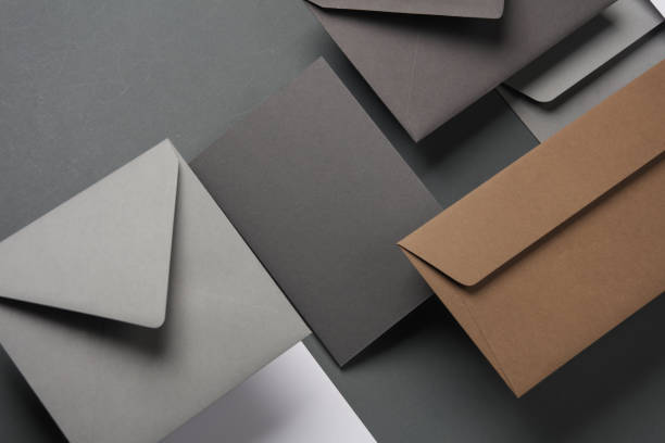 istock Floating envelopes and cards on dark gray background with shadow. Minimalism, modern business still life, creative layout 2042050006